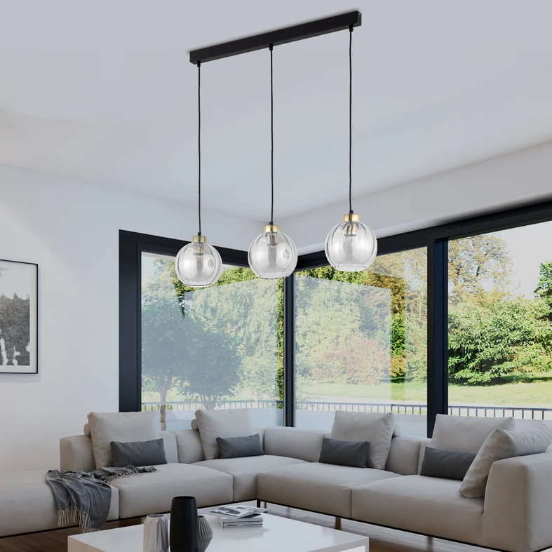 Potrójna lampa DEVI posiada podsufitkę o kształcie listwy i metalową oprawę kloszy wykończeniem w złotym połysku.