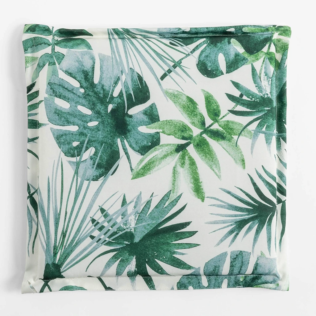 Kwadratowa, płaska poduszka ogrodowa, o wzorze zielonych liści na białym tle, o gładkim, białym tyle.