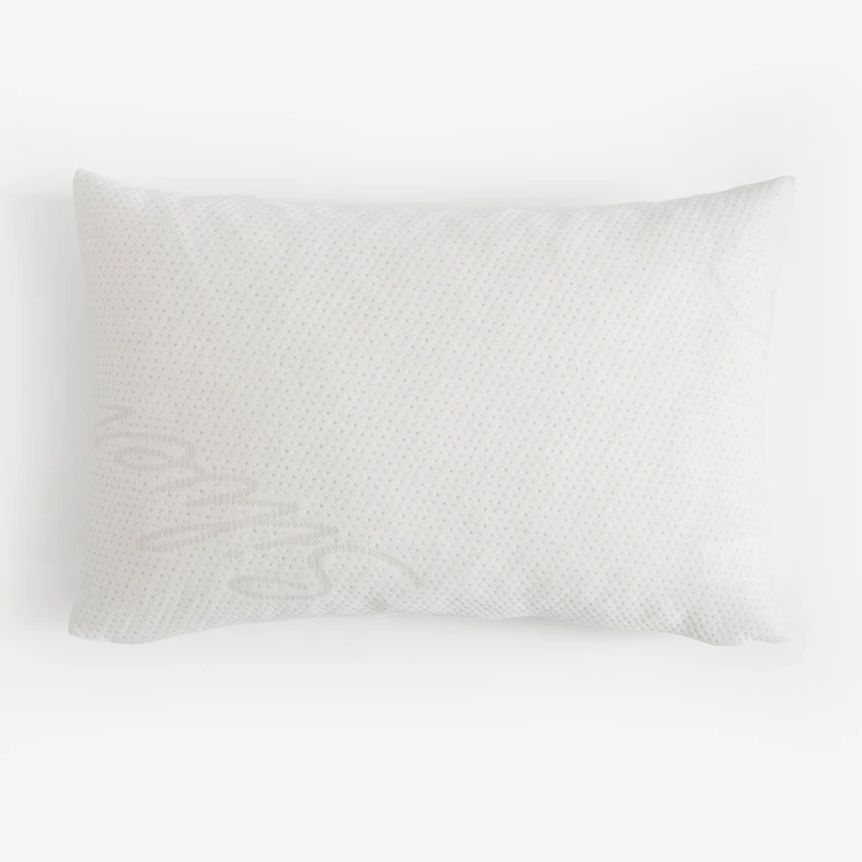 Biała prostokątna poduszka o pikowanej fakturze z jonami srebra.