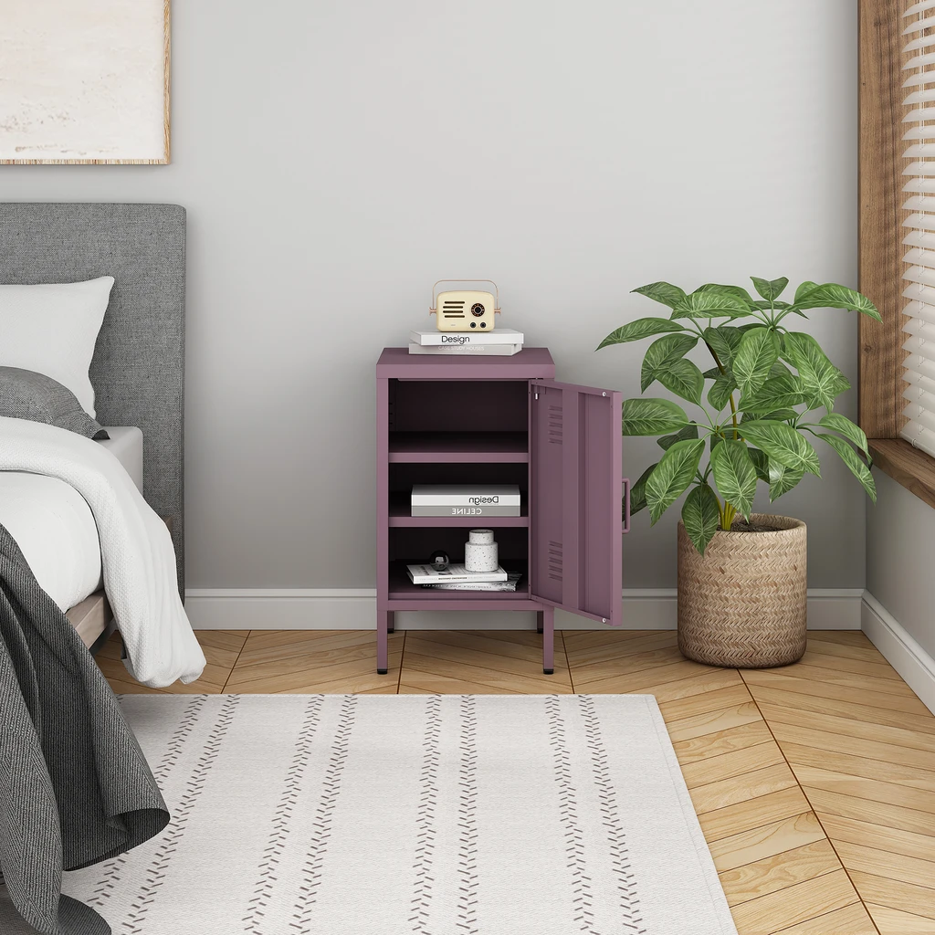 Fioletowa, metalowa szafka nocna na wysokich nóżkach.
